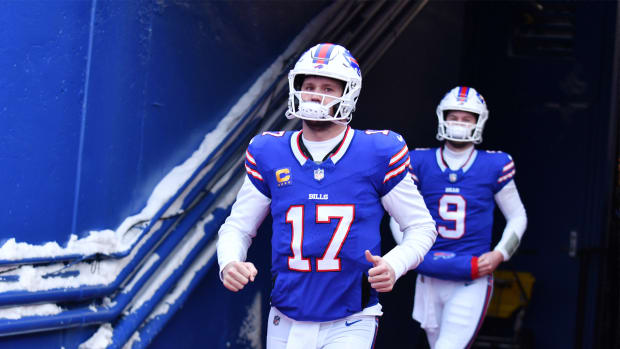 Buffalo Bills quarterback Josh Allen runs onto the field before an NFL Playoff game.